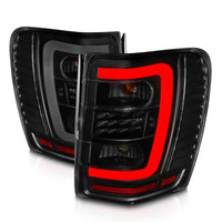 ANZO 1999-2004 Jeep Grand Cherokee LED Tail Lights w/ Light Bar Black Housing Smoke Lens - Burkken Auto Parts